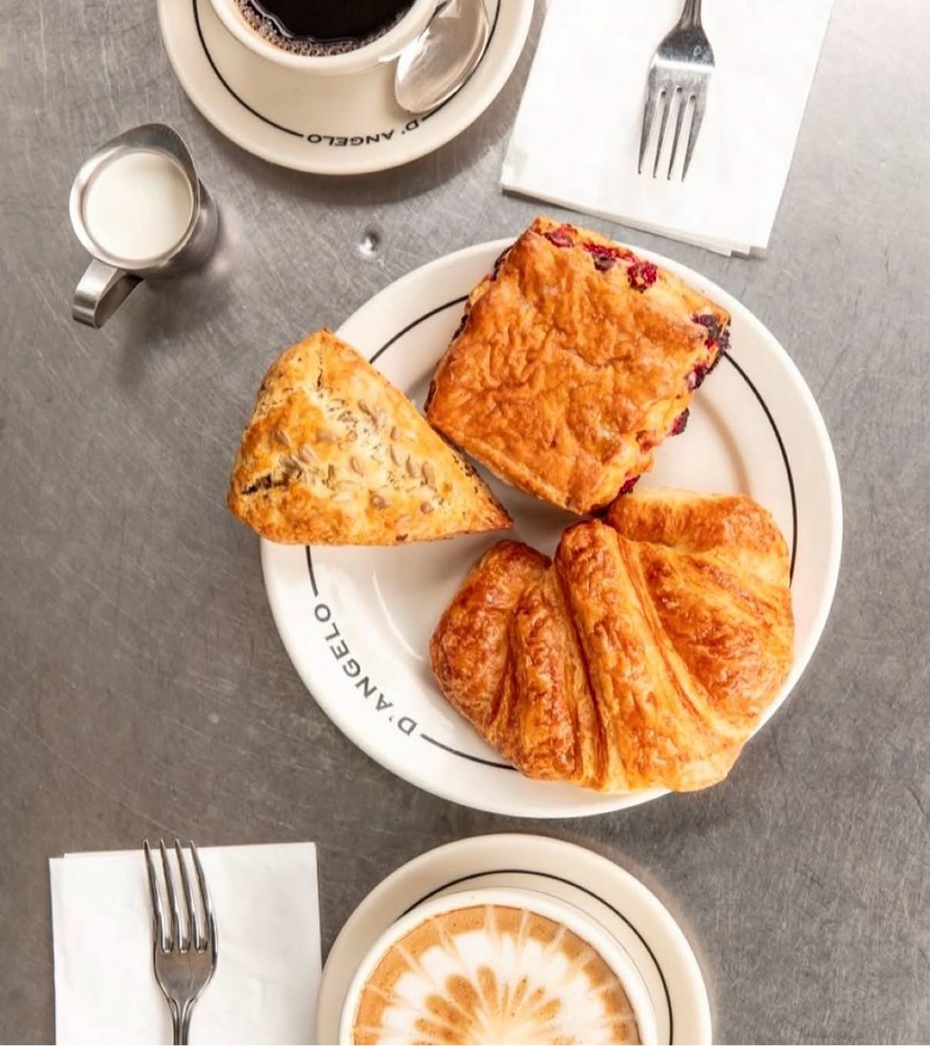 Warm almond croissant & cappuccino on D'ANGELO signature plate