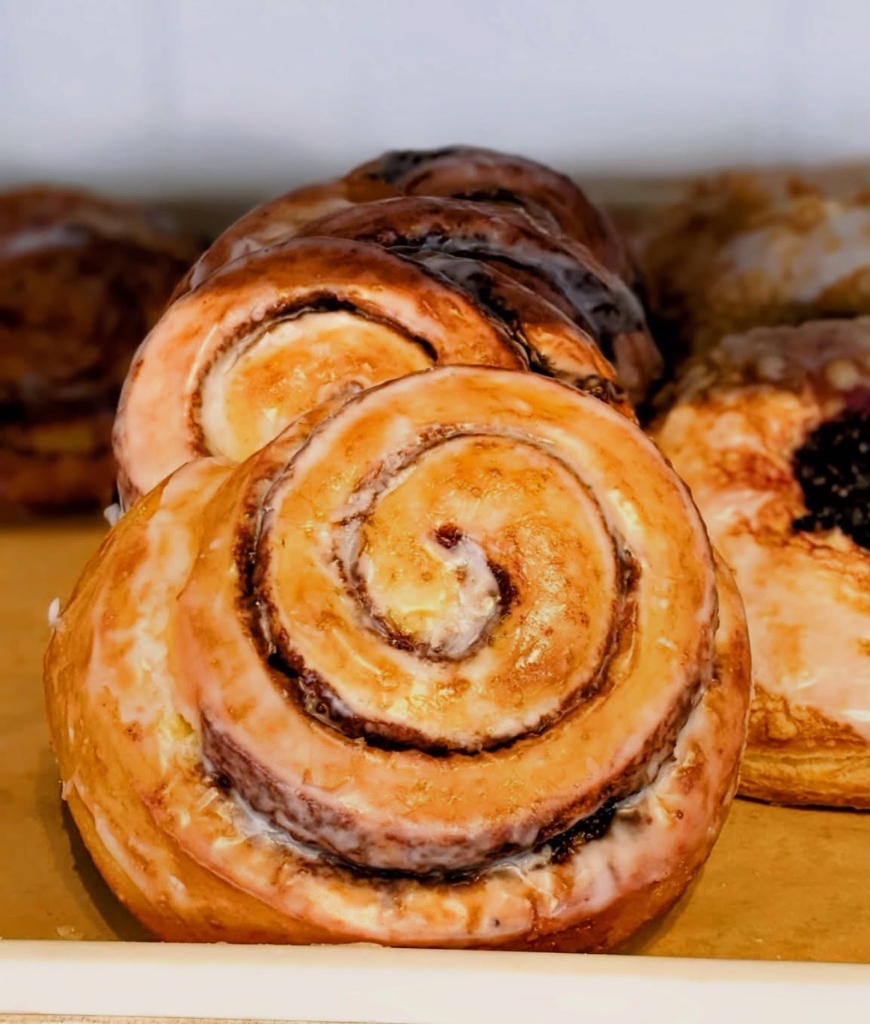 Fresh glazed cinnamon rolls baked daily in house